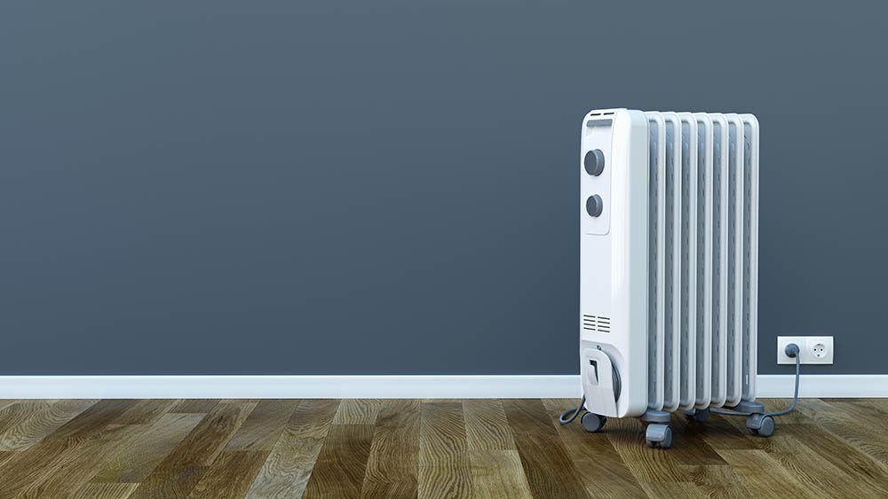 Electric heater against blue wall