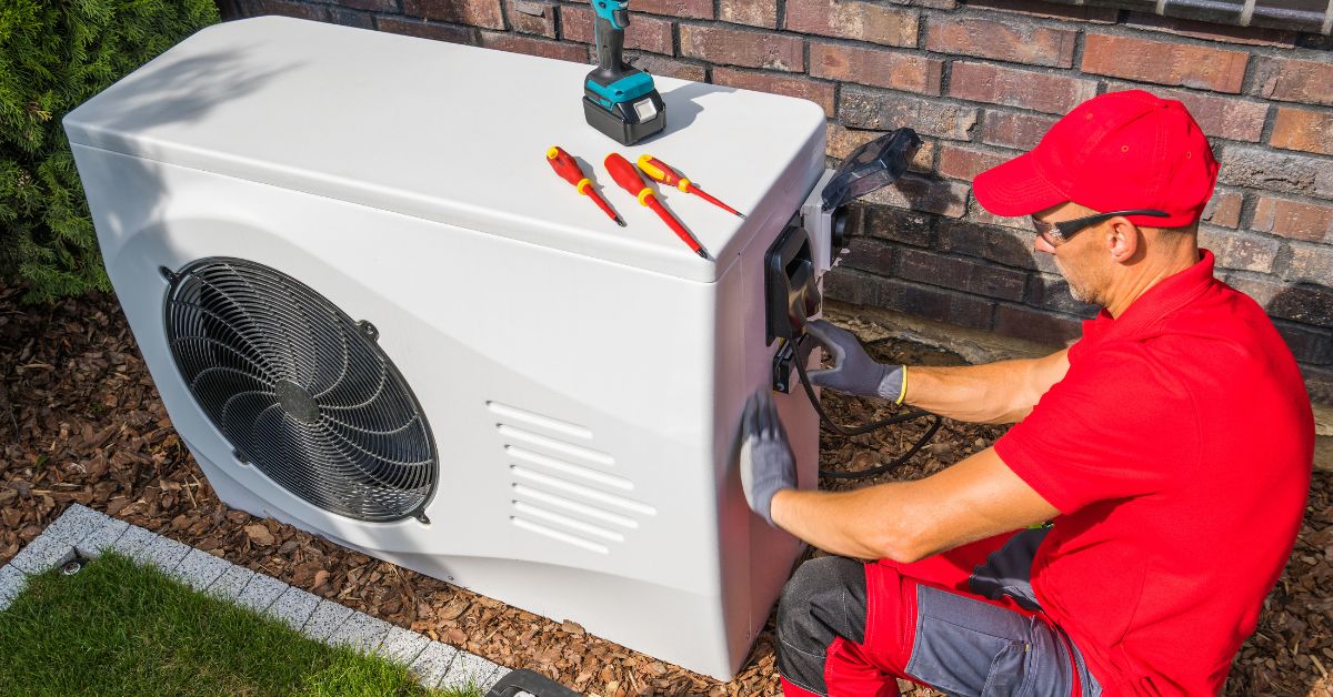 HVAC technician working on heat pump